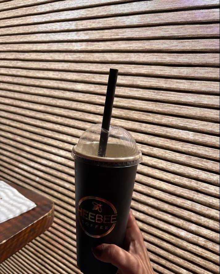 Cold brew in HeeBee tumbler against wooden slats