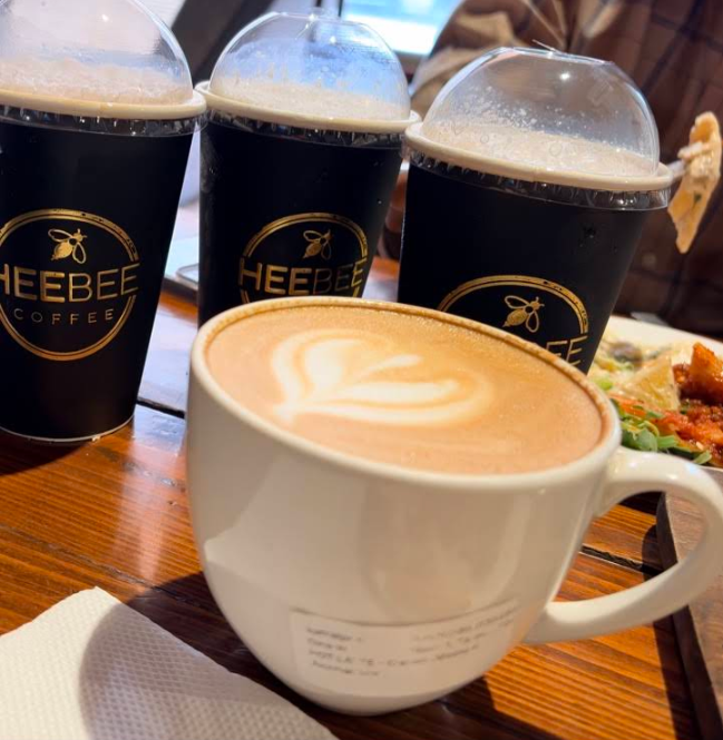 Row of HeeBee takeaway cups with logo